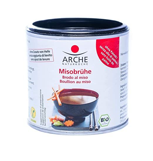 Lattina di brodo miso Arche con indicazioni bio, senza lievito e senza olio di palma. Mostra una ciotola di zuppa miso.