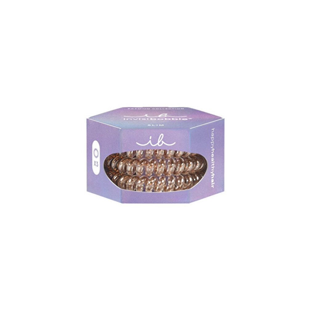 Confezione esagonale con tre elastici per capelli color bronzo. Marchio: invisibobble. Modello Slim.