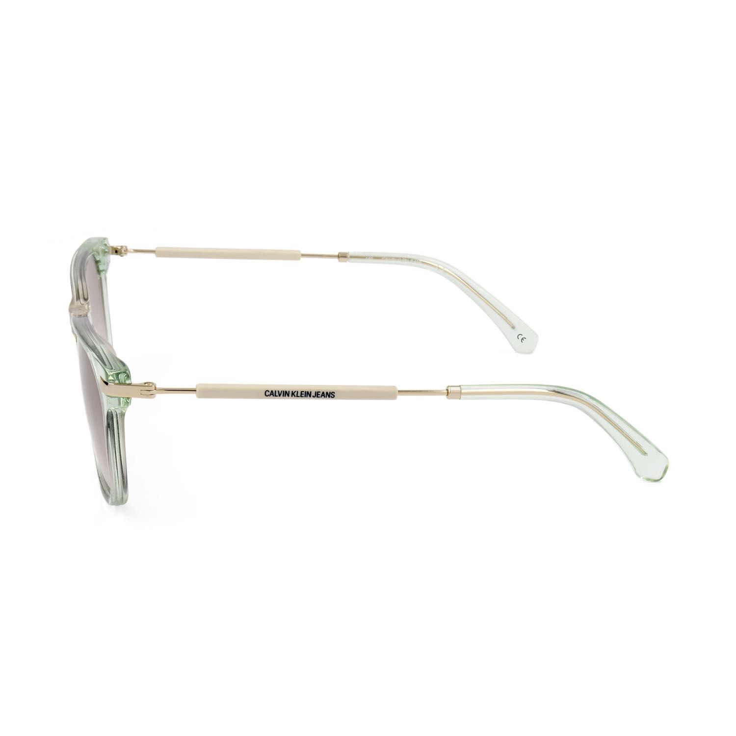 Occhiali da sole verde chiaro trasparenti con aste argentate e scritta "CALVIN KLEIN JEANS".