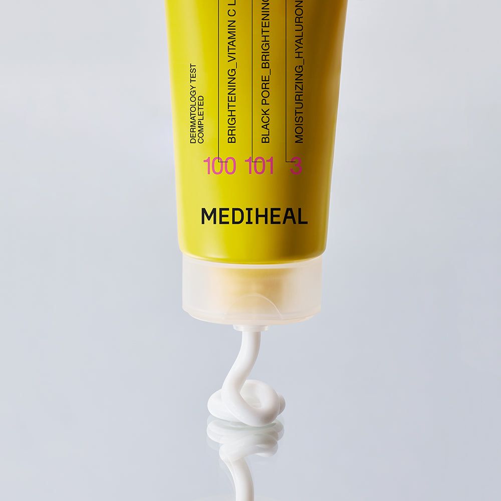 Tubo con prodotto bianco. Scritta: MEDIHEAL. Striscia gialla con testo. Prodotto che esce dal tubo.