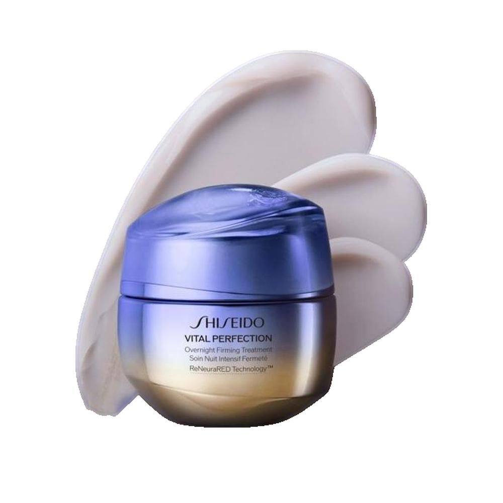 Vaso di crema sfumato blu-oro con strisce di crema. Scritta: Shiseido Vital Perfection Overnight Firming Treatment.