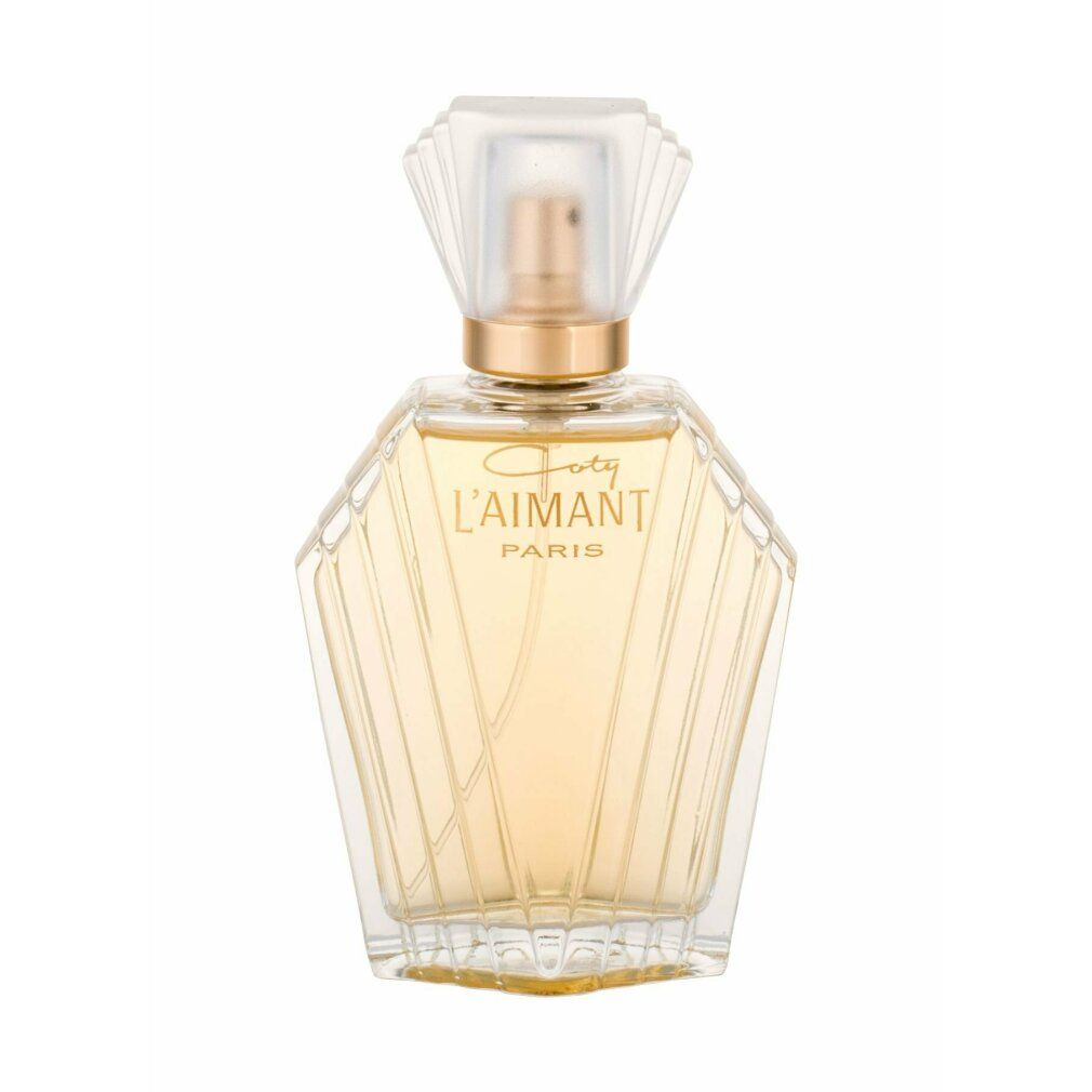 Flacone di profumo Coty L'Aimant. Flacone in vetro trasparente con vaporizzatore e tappo dorati. Scritta.