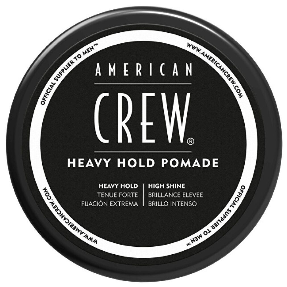 Coperchio nero della pomata American Crew Heavy Hold. Nome e dettagli del prodotto in bianco. Con testo in inglese, spagnolo e francese.