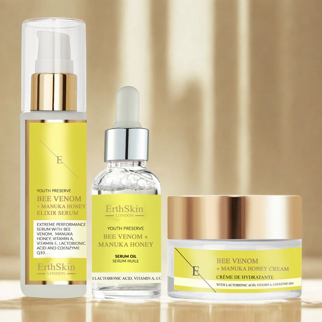 Tre prodotti ErthSkin: siero, olio e crema. Etichette gialle con testo e logo. Contenitori in vetro e plastica.