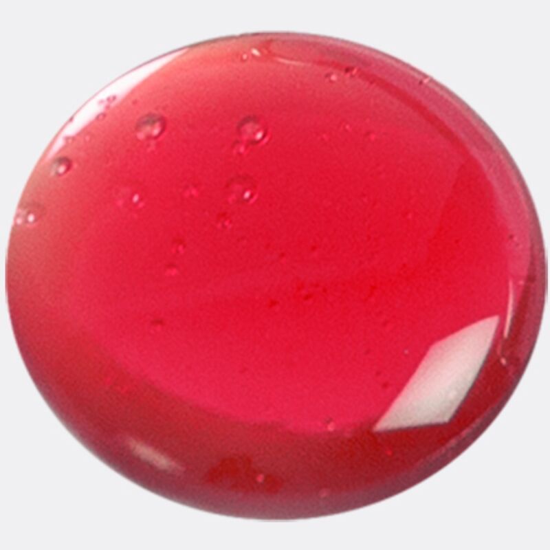 Primo piano di un gel rosso rotondo con bolle.