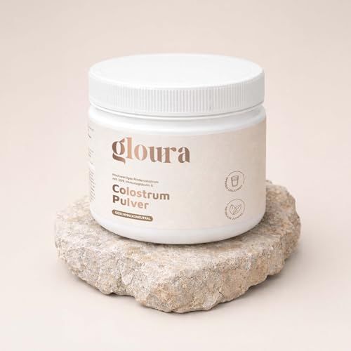 Contenitore bianco con scritta Gloura posto su una pietra. Sfondo beige.