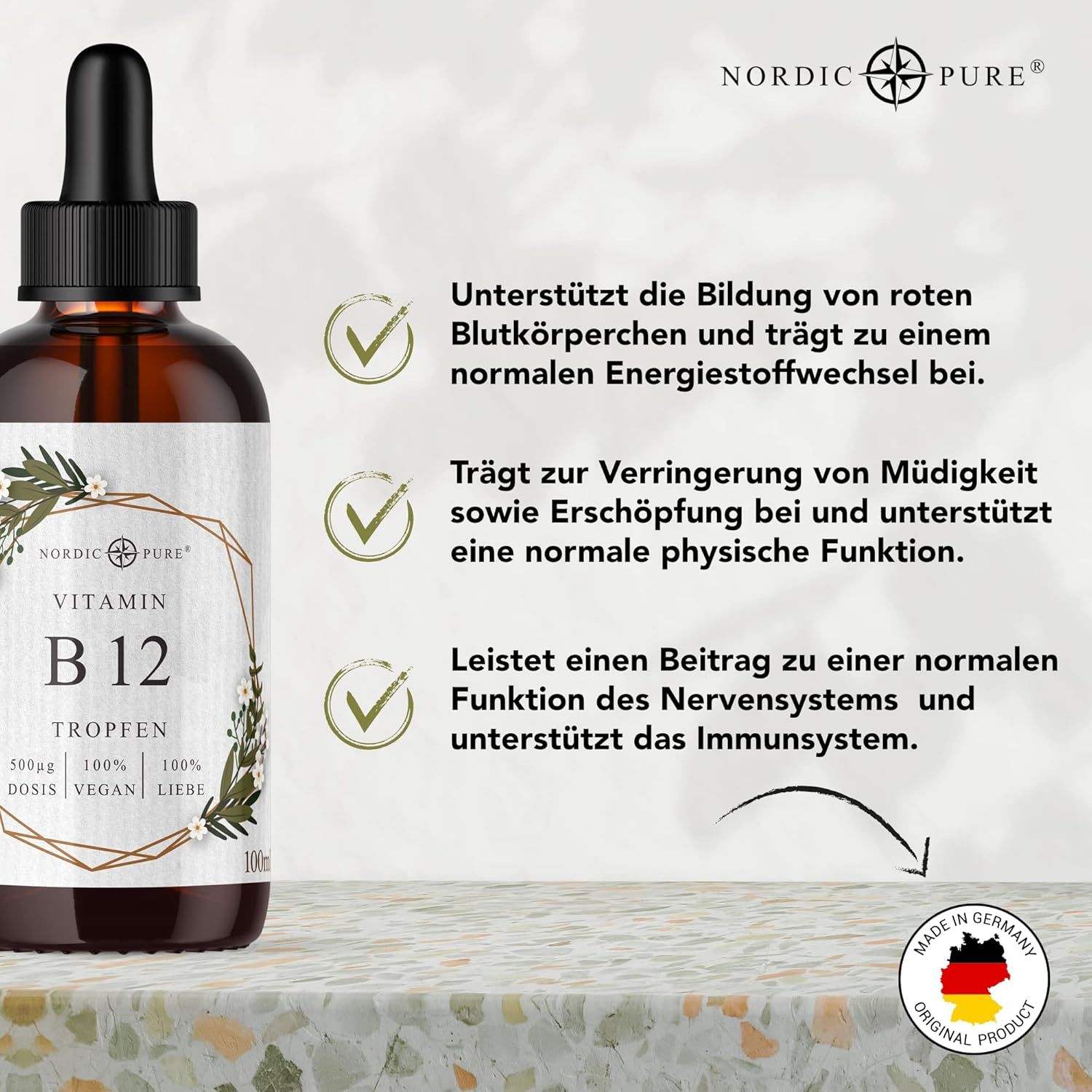 Flacone marrone con contagocce. Testo: Vitamin B12 Tropfen, Nordic Pure. Testo: Supporta globuli rossi, energia, affaticamento, sistema nervoso.