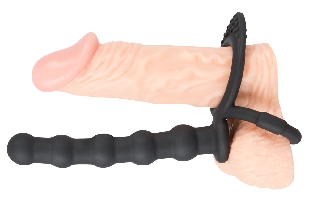 Pene con anello per pene/testicoli nero e dildo anale. Anello con rilievi, dildo scanalato. Silicone.