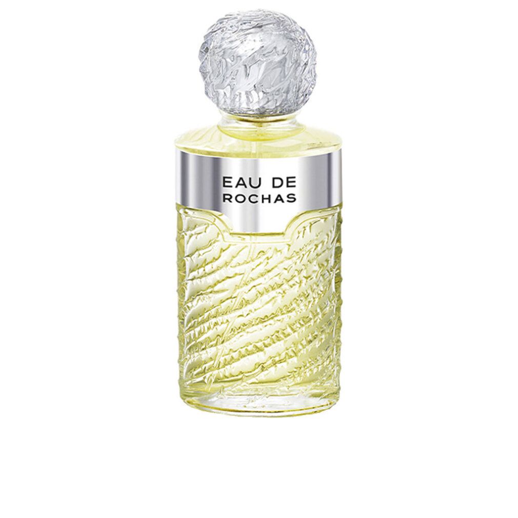 Flacone di profumo con tappo ed etichetta argentati. Flacone con texture scanalata e liquido giallastro.