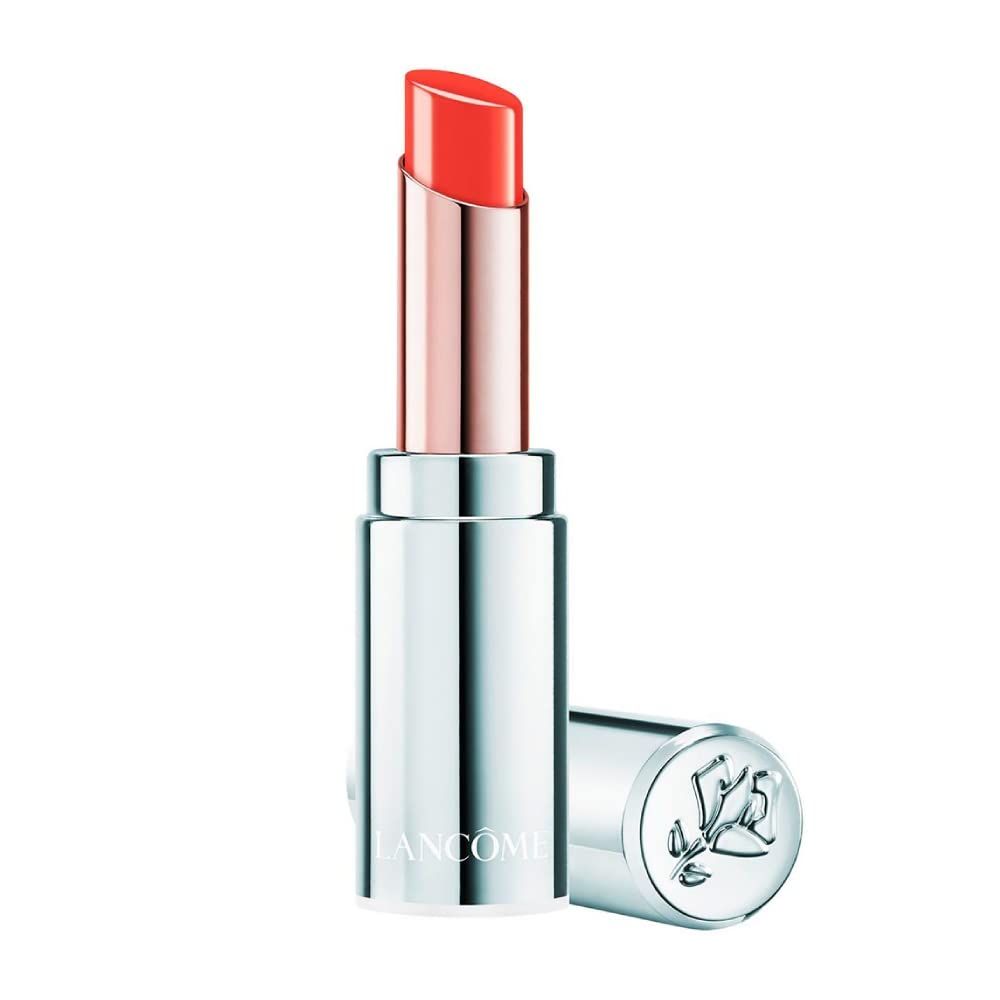 Balsamo labbra arancione in astuccio argentato. Logo Lancôme sul fondo. Tappo accanto.