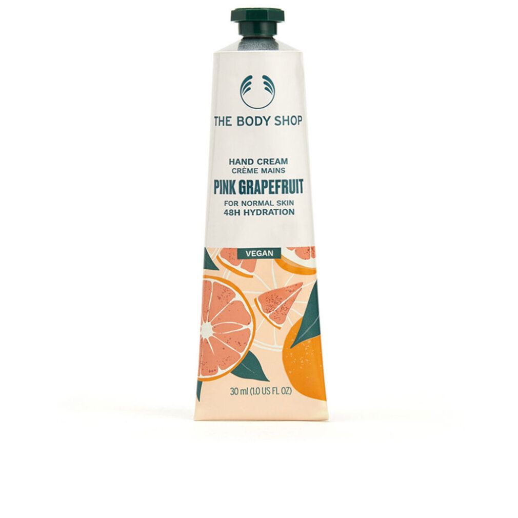Tubo di crema mani. Bianco, tappo verde. Scritta: Pink Grapefruit, Vegan. Illustrazioni di pompelmo. Marchio: The Body Shop.