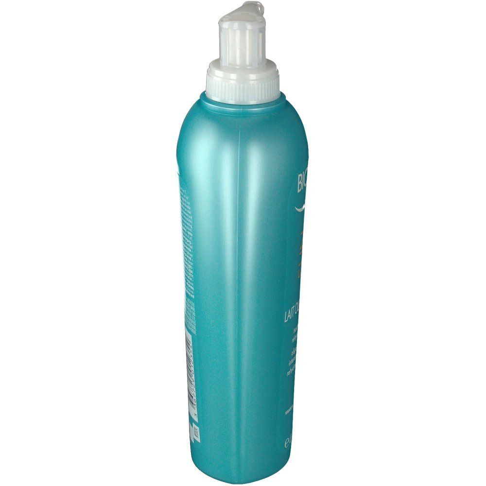 Flacone turchese con dosatore, vista laterale. Testo sul flacone.