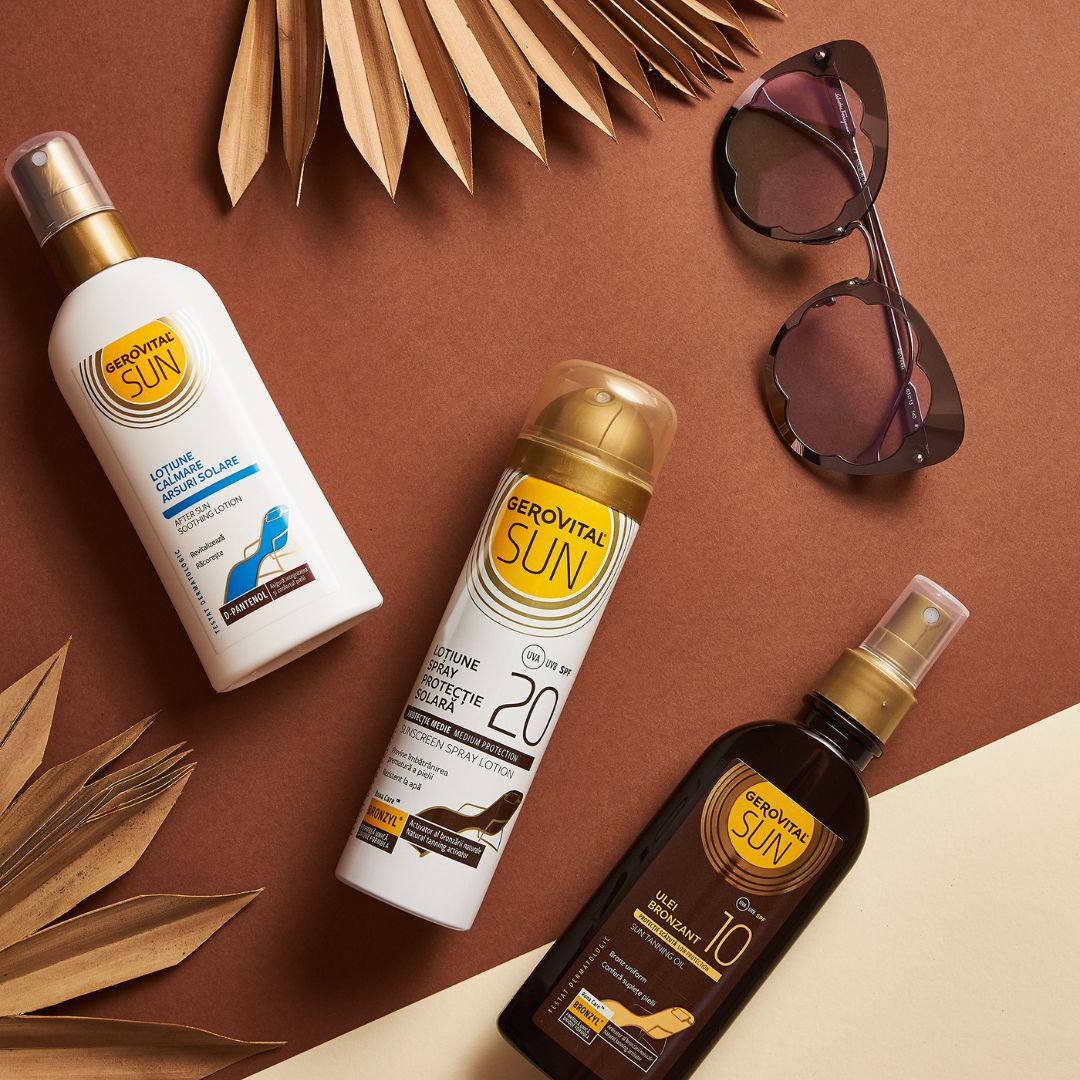 Tre prodotti Gerovital Sun: olio abbronzante, crema solare SPF 20, lozione doposole. Occhiali da sole e foglie sullo sfondo.