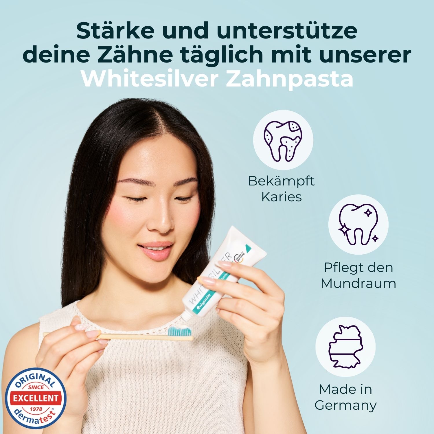 Donna che tiene in mano un tubetto di dentifricio. Dentifricio WhiterSilver. Testo: Rafforza e supporta i tuoi denti quotidianamente. Sigillo Dermatest.