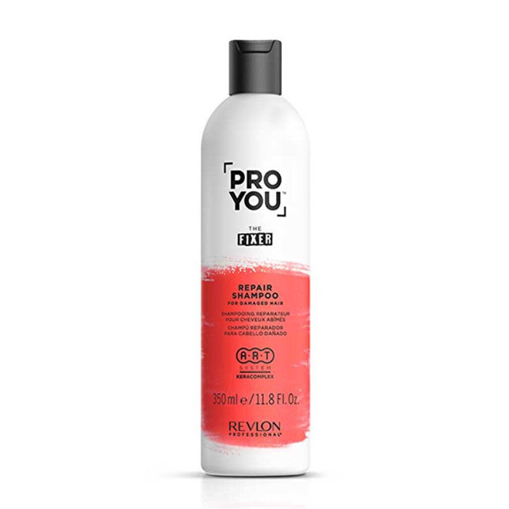 Flacone bianco con tappo nero. Scritta: PRO YOU THE FIXER REPAIR SHAMPOO. 350ml/11.8 Fl. Oz. Revlon Professional.