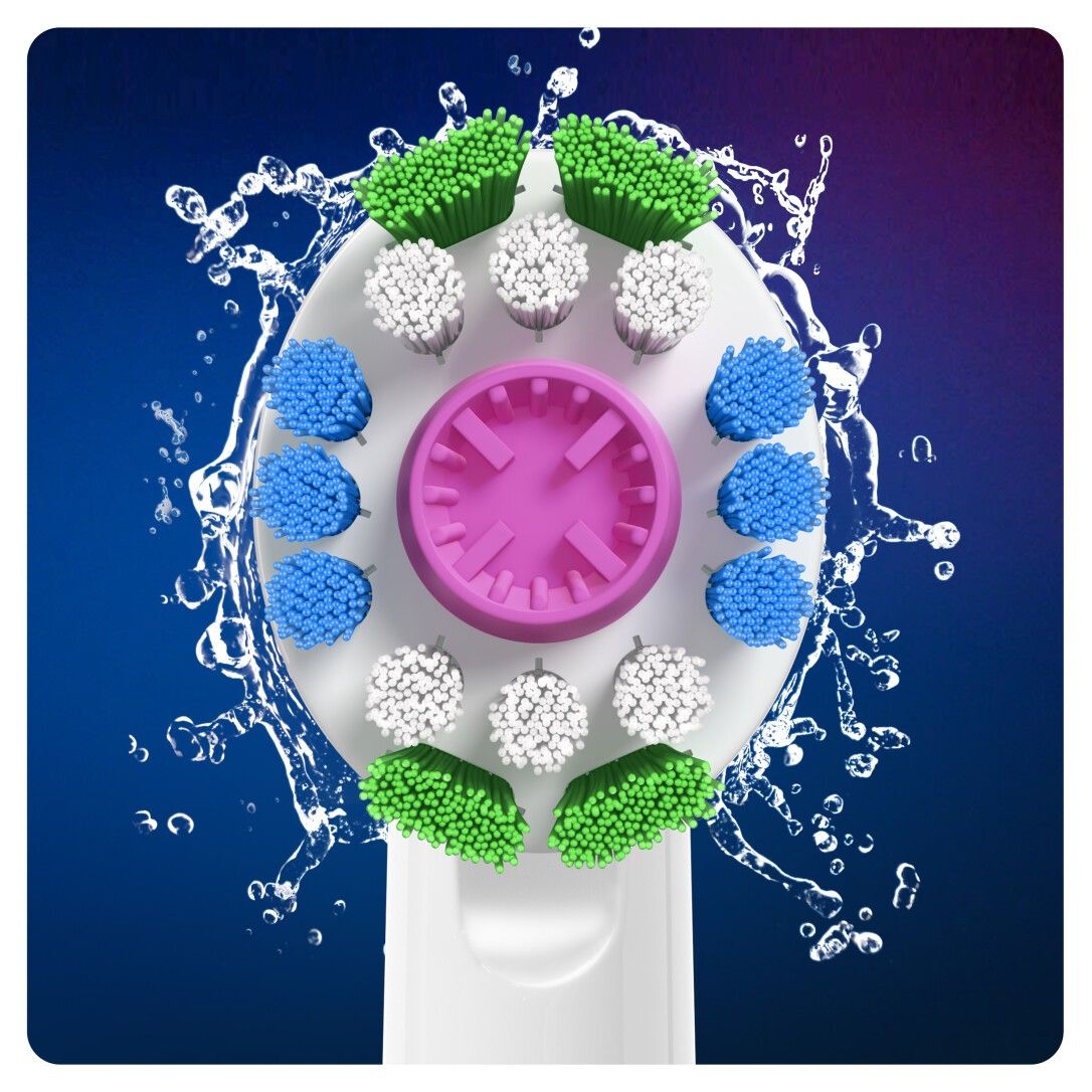 Primo piano di una testina. Setole verdi, bianche, blu e rosa. Schizzi d'acqua.