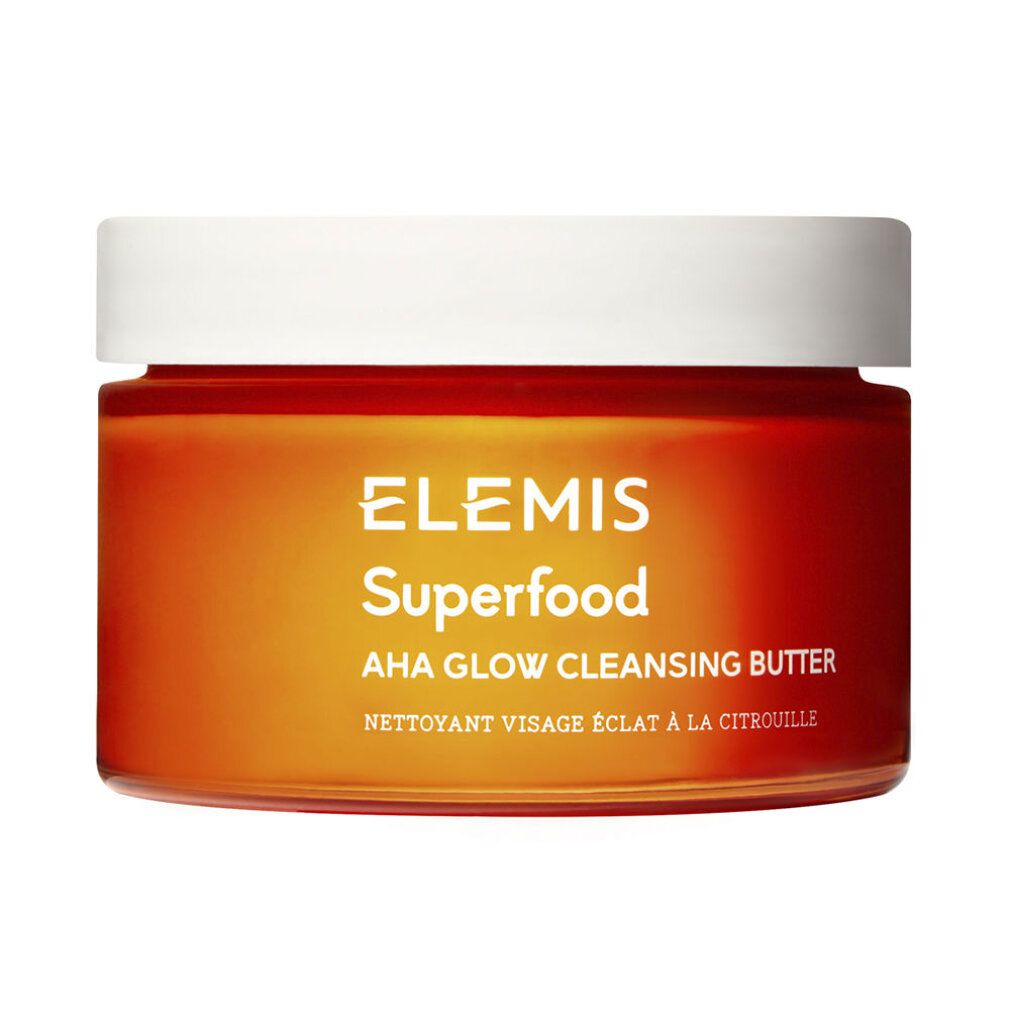 Elemis Superfood AHA Glow Cleansing Butter in un barattolo di vetro arancione con coperchio bianco.