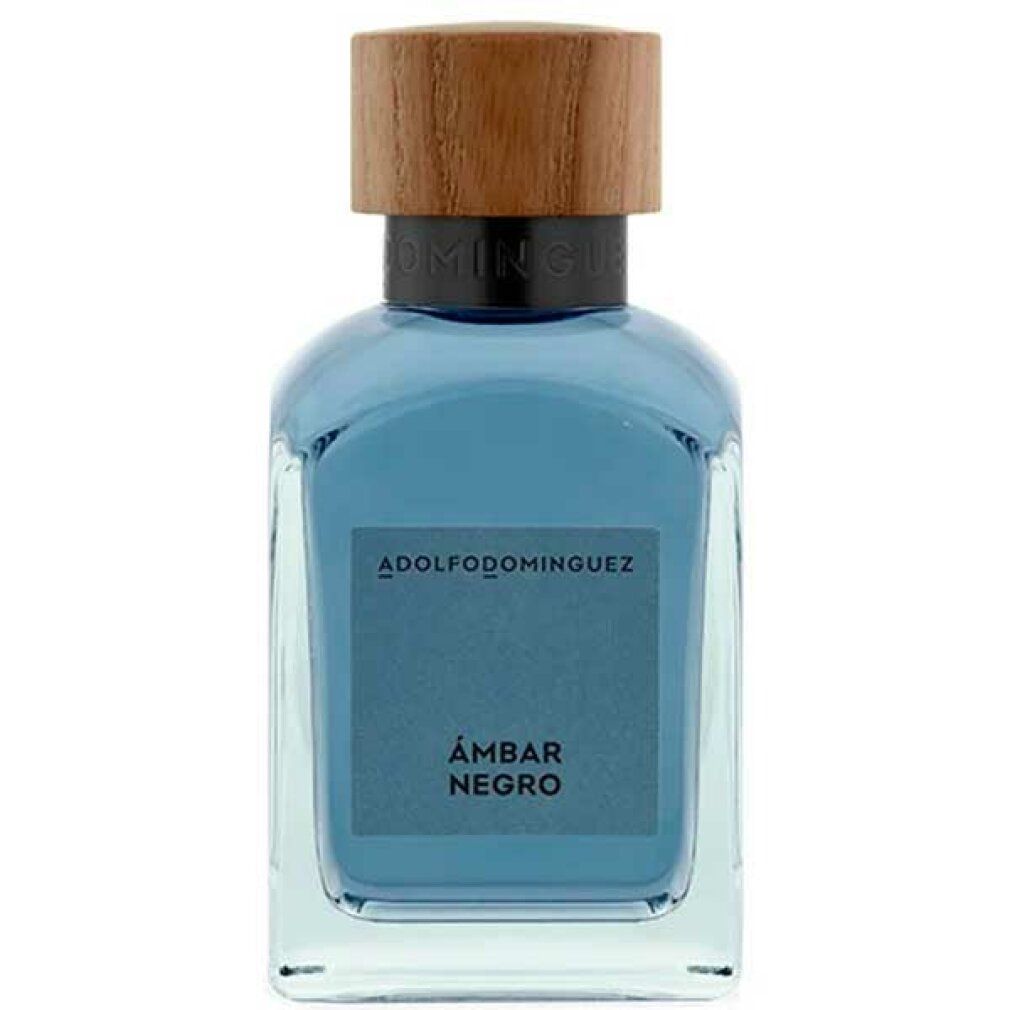 Flacone in vetro con tappo in legno. Scritta: ADOLFODOMINGUEZ, ÁMBAR NEGRO. Liquido blu visibile.