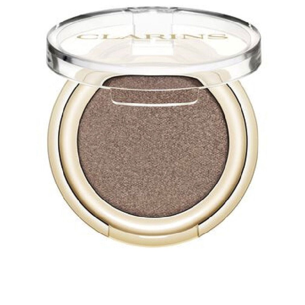 Ombretto Clarins rotondo, dorato. Coperchio aperto. Interno: Satin Taupe. Scritta Clarins.