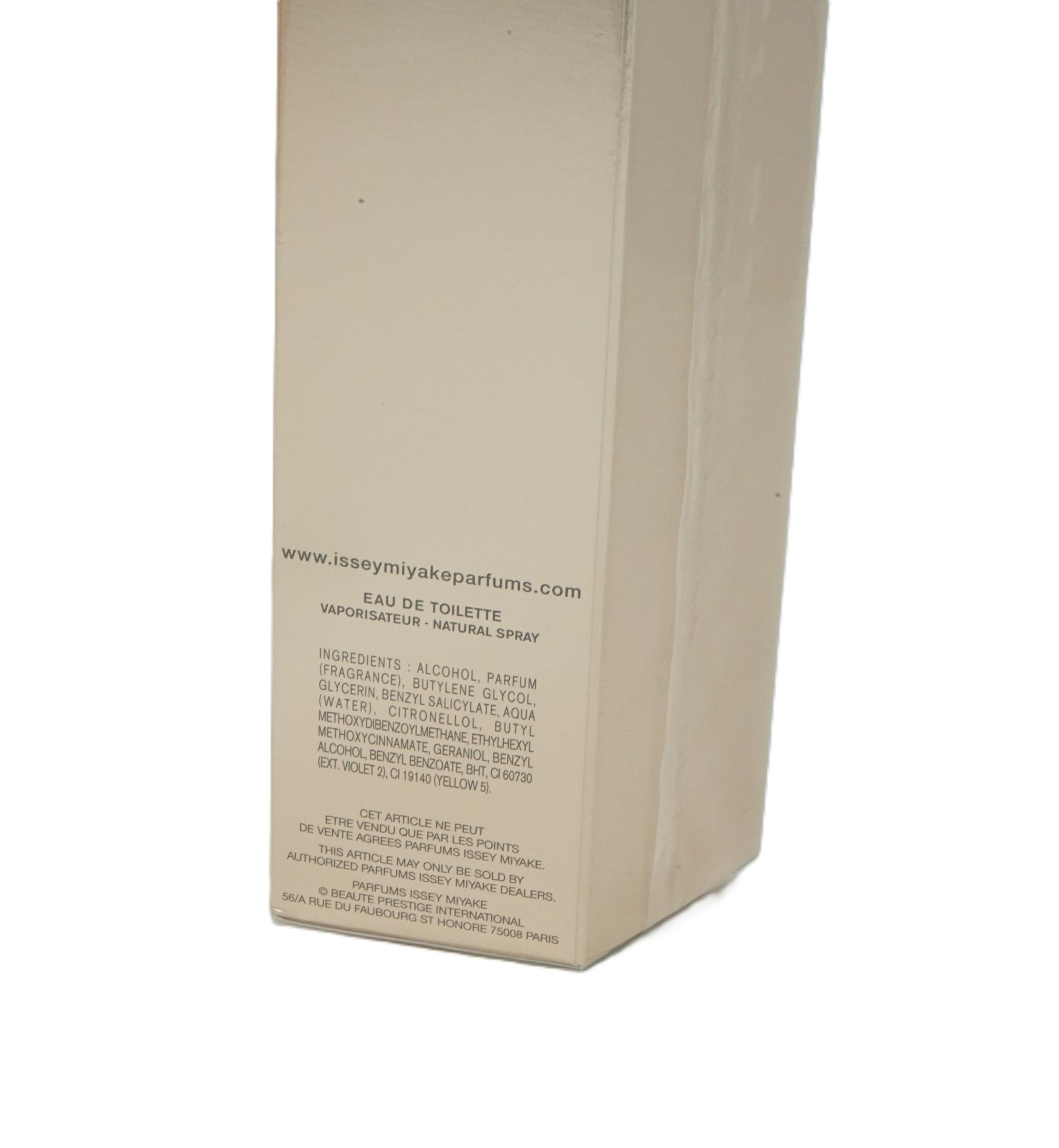 Scatola di cartone beige con testo. Contiene informazioni come ingredienti, sito web e indirizzo del produttore. "Eau de Toilette".