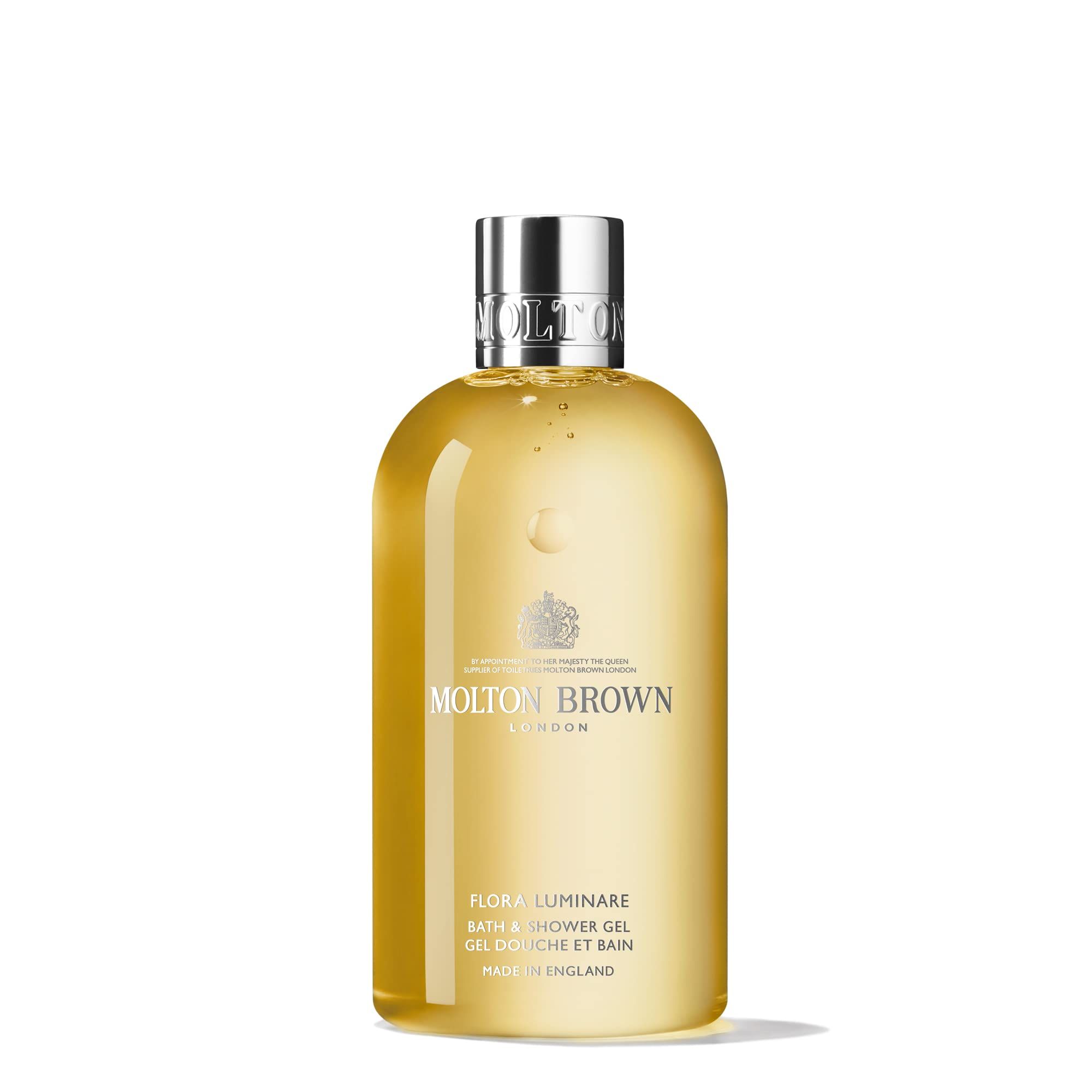 Flacone giallo con tappo argentato. Scritta: Molton Brown London, Flora Luminare Bath & Shower Gel. Made in England.