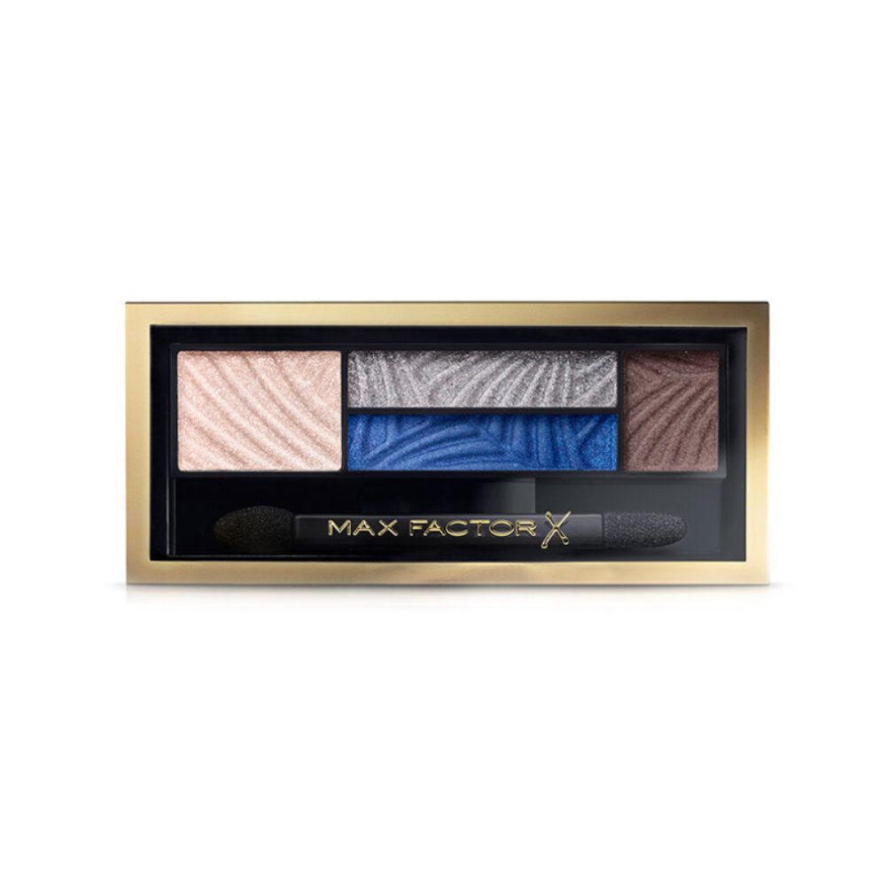 Palette ombretti con cinque colori, blu e marrone. Cornice dorata, applicatore nero. Scritta: MAX FACTOR.