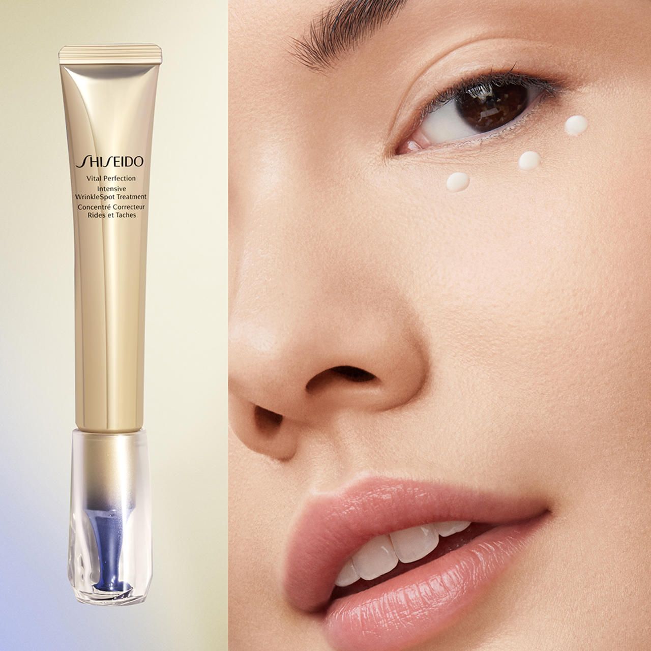 Prodotto accanto al viso. Tubo dorato con applicatore blu. Scritta: SHISEIDO Vital Perfection Intensive Wrinklespot Treatment.