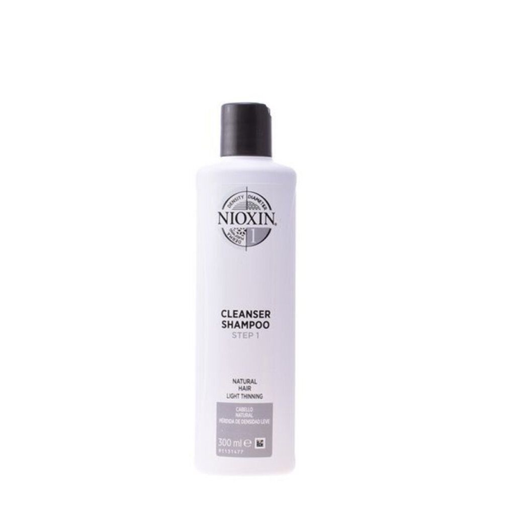 Flacone di shampoo bianco con tappo nero. Scritta: Nioxin, Cleanser Shampoo, Step 1. Per capelli fini. Volume.