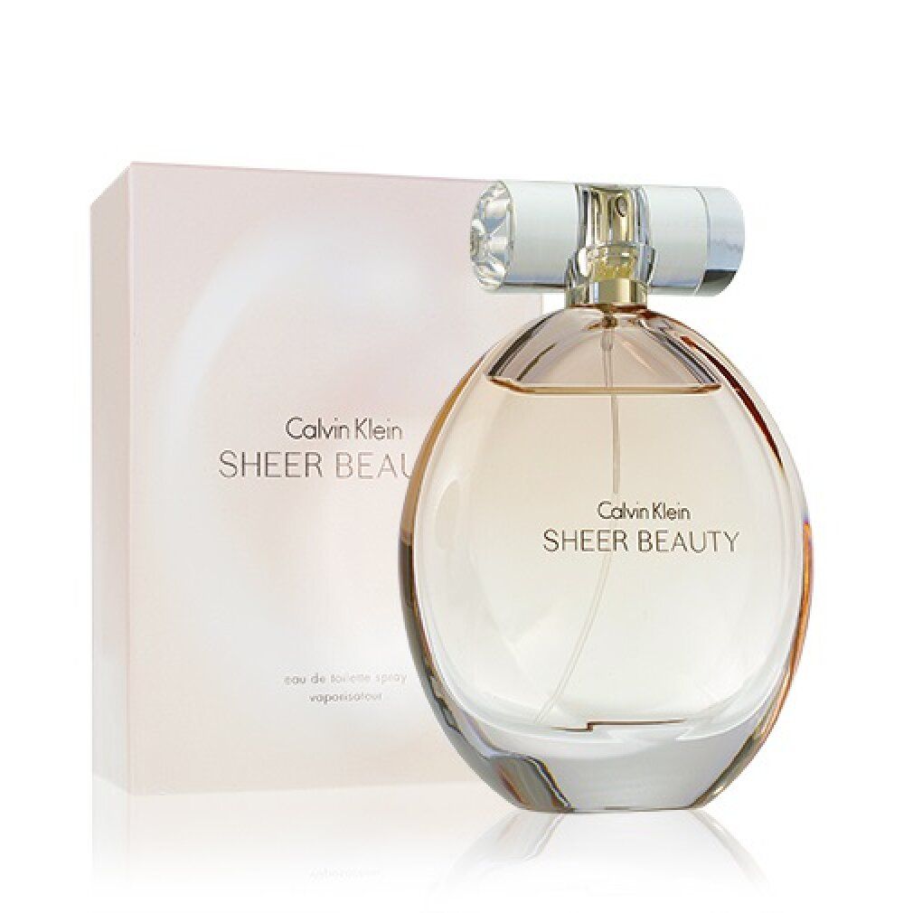 Flacone e confezione profumo. Scritta: Calvin Klein Sheer Beauty. Flacone rotondo, liquido rosa.