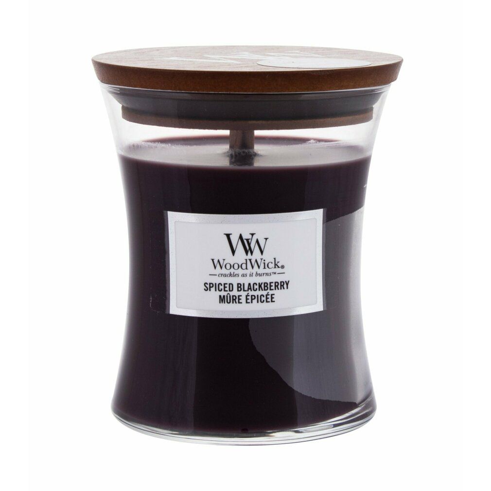 Candela a forma di clessidra con coperchio in legno. Cera viola scuro, etichetta bianca con testo. Contenitore di vetro. Nome del prodotto sull'etichetta.