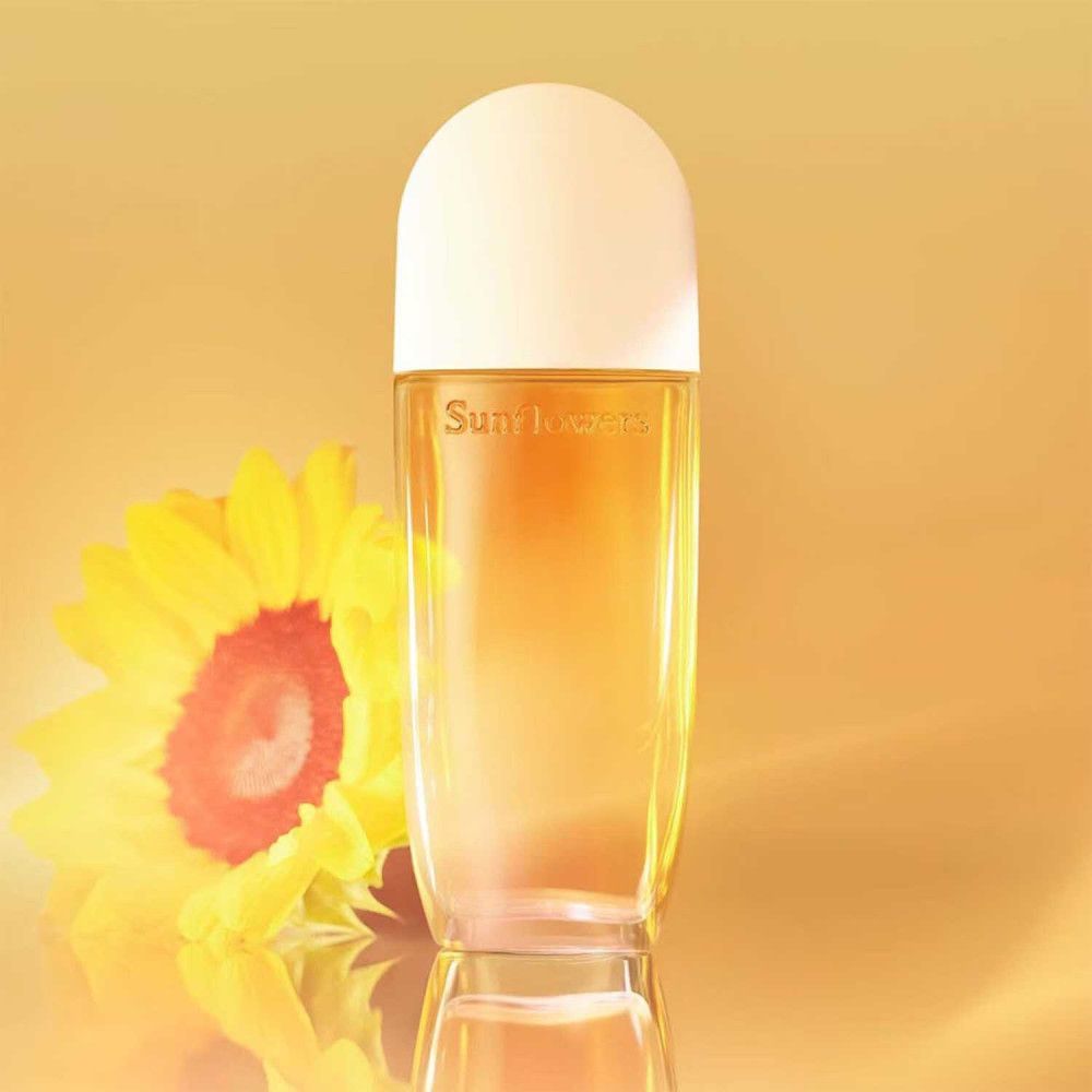 Flacone di profumo Sunflowers con tappo bianco. Girasole sullo sfondo.