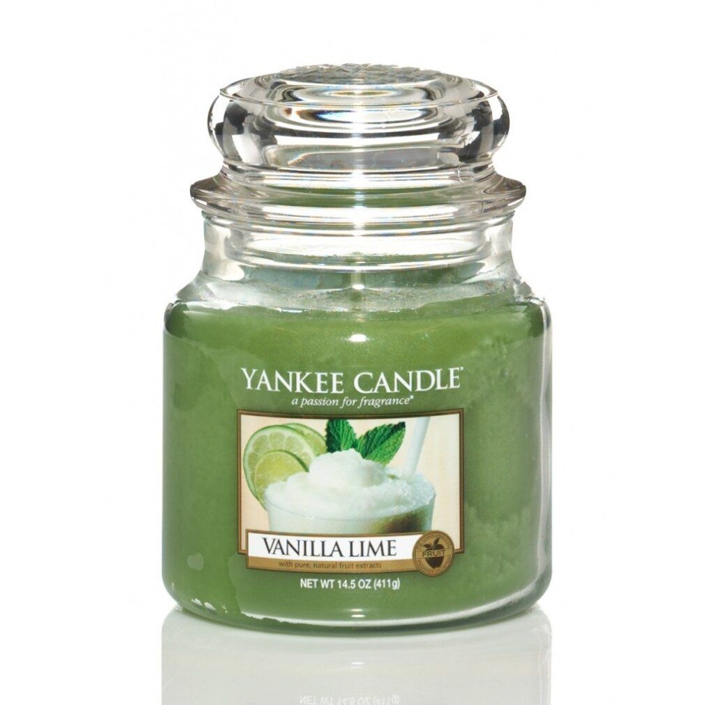 Candela verde in vaso con coperchio. Etichetta con motivo vaniglia-lime. Scritta: Vanilla Lime. Contenitore di vetro.