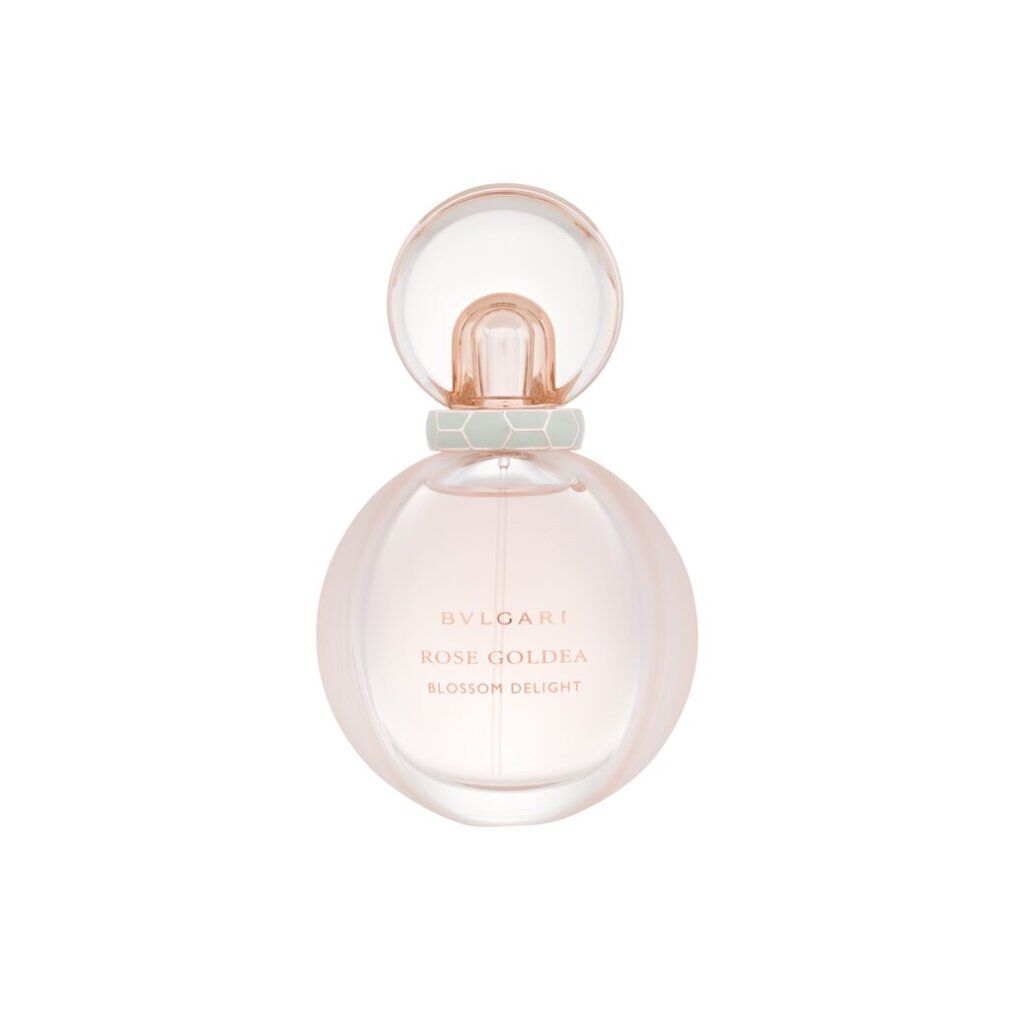 Flacone di profumo rotondo con liquido rosa. Tappo dorato, anello verde. Nome del prodotto sul flacone.