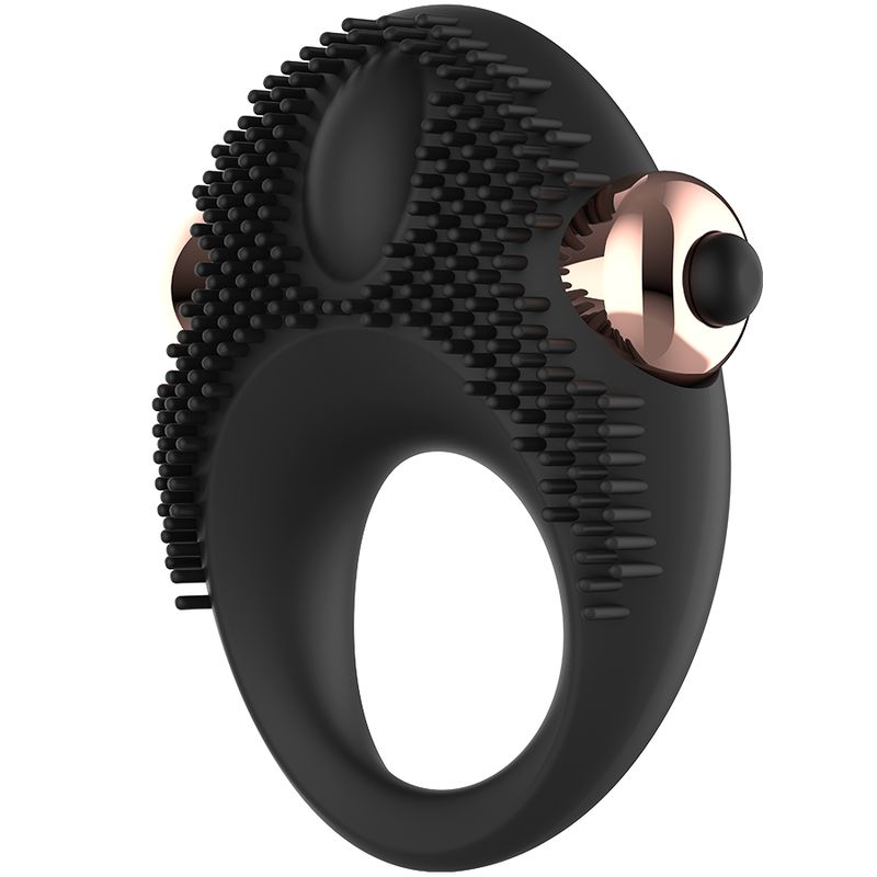 Anello vibrante per pene in silicone nero. Anulare con borchie e due elementi oro rosa. Pulsante nero.