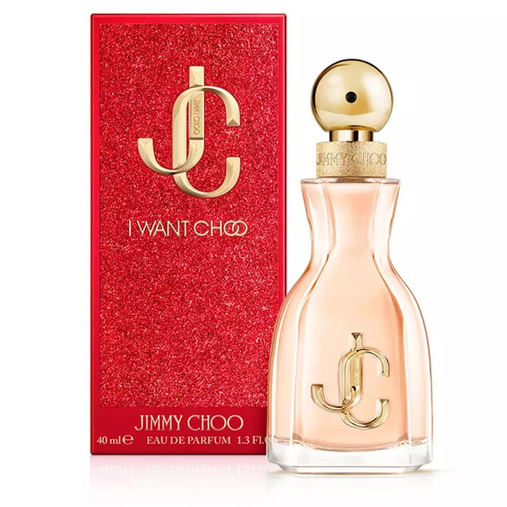 Flacone di profumo accanto alla confezione rossa. Flacone con tappo e logo dorati. Confezione con "I WANT CHOO" e "JIMMY CHOO".