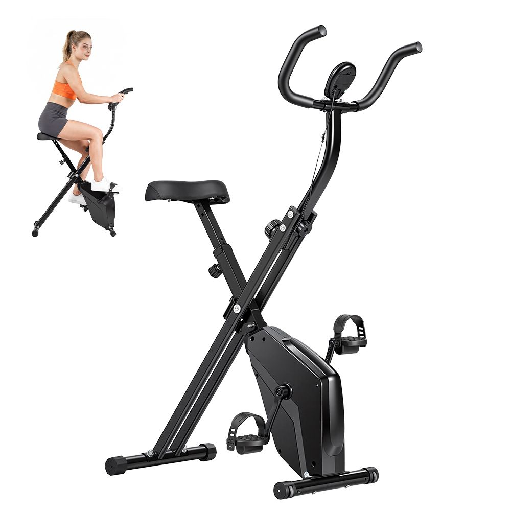 Bicicletta da allenamento pieghevole nera. Donna sopra. Sella, manubrio, pedali e display. Telaio in metallo.