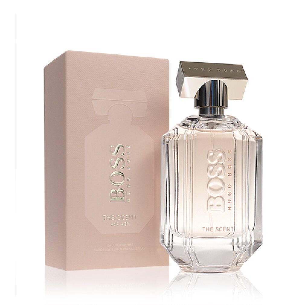 Flacone di profumo e confezione. Flacone con tappo argentato e scritta BOSS THE SCENT. Confezione rosa con immagine del prodotto.