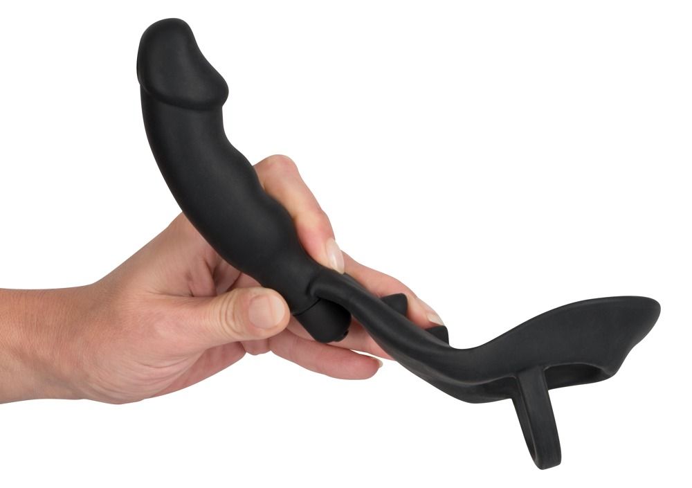 Anello per pene/scroto nero con plug anale. Parte ad anello, asta curva con forma di pene, plug anale all'estremità. Silicone.