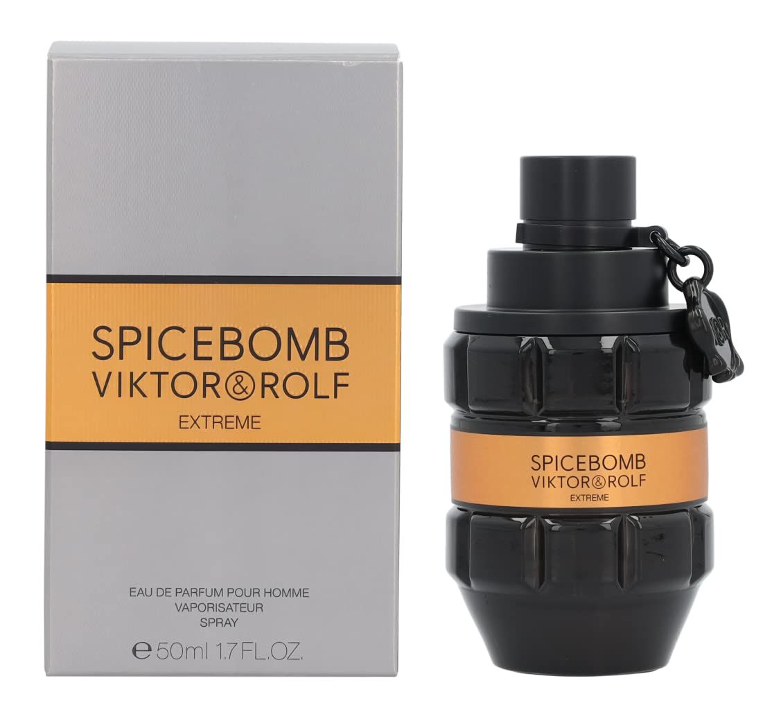 Flacone nero con etichetta dorata e scritta. Accanto, una scatola grigia con una striscia gialla e scritta.