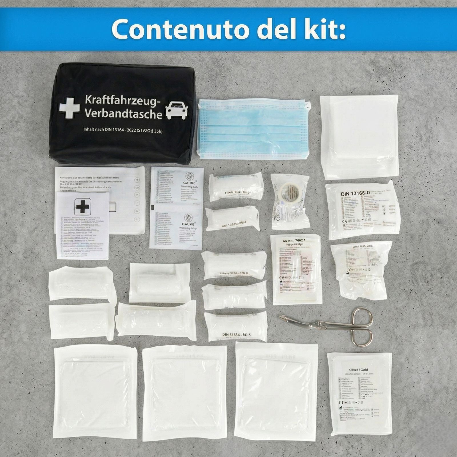 Contenuto della borsa di pronto soccorso. Bende, mascherine, forbici e altri articoli medici.