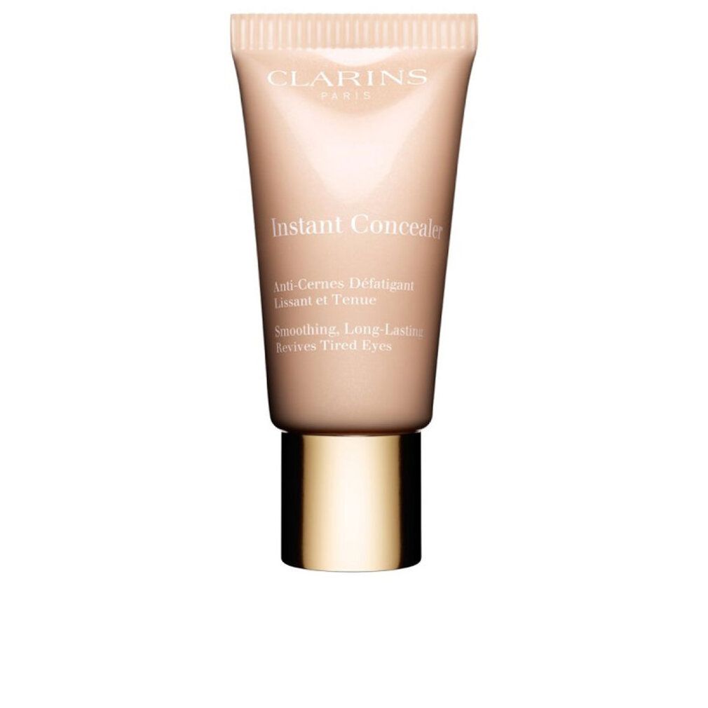 Tubo correttore beige Clarins. Scritta: Instant Concealer. Anti-Cernes Défatiguer. Levigante, lunga durata, ravviva gli occhi stanchi.