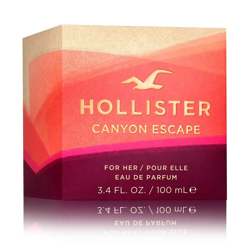 Confezione Hollister Canyon Escape Eau de Parfum Spray. Sfumatura di rosso e beige. Logo e nome del prodotto in oro.