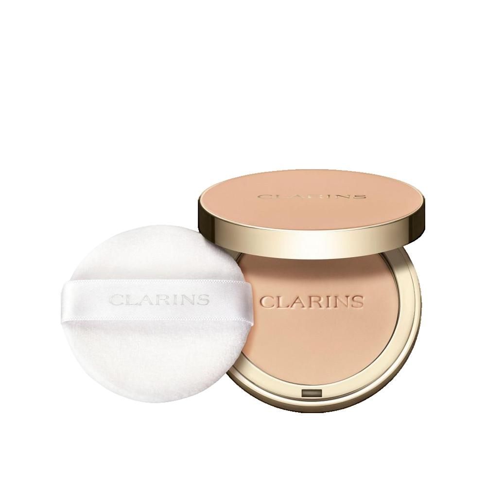 Cipria compatta con specchio e applicatore. Coperchio dorato con scritta. Cipria in tonalità chiara. Applicatore con nastro e scritta.