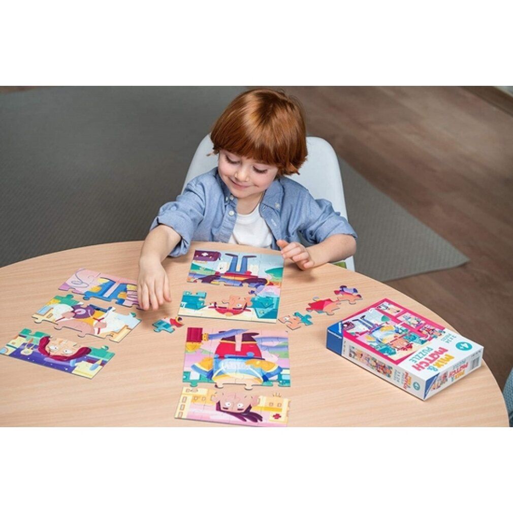 Bambino che gioca con un puzzle. Pezzi del puzzle e scatola del puzzle su un tavolo. La scatola mostra il motivo del puzzle.