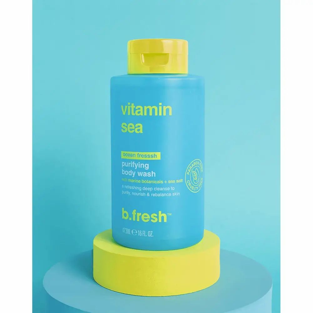 Bagnoschiuma blu con tappo giallo. Scritta "Vitamin Sea" e "b.fresh". Poggia su un piedistallo giallo.