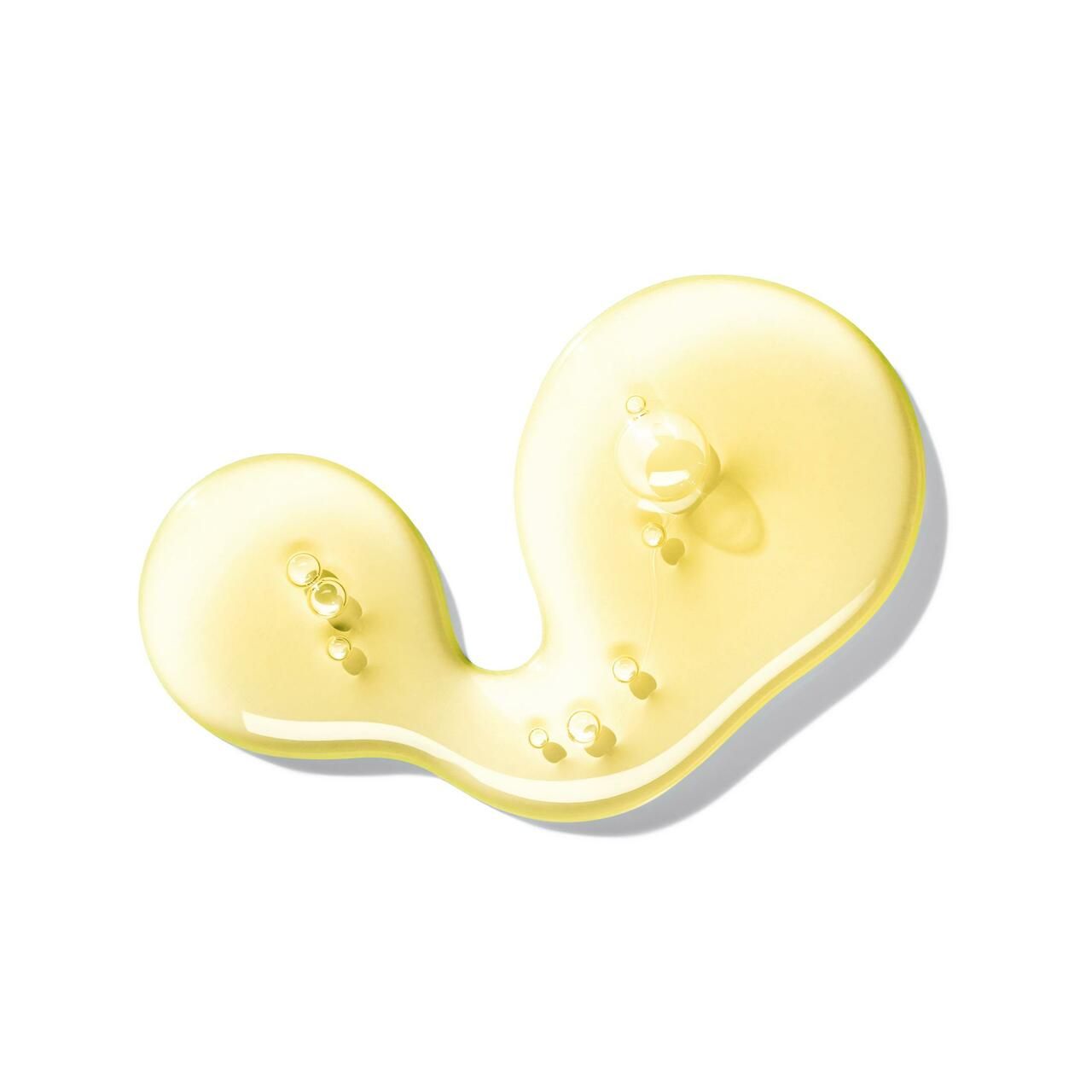 Liquido giallo, presumibilmente sapone, su sfondo bianco. A forma di goccia con diverse piccole bolle.