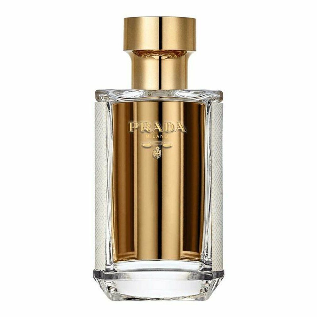 Flacone di profumo con tappo dorato. Scritta: PRADA. Forma rettangolare con interno dorato e motivo bianco sui lati.