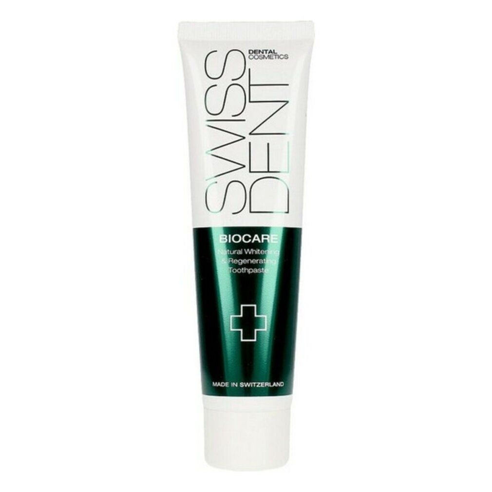 Tubo di dentifricio bianco e verde. Scritte: SWISSDENT, BIOCARE, Natural Whitening & Regenerating Toothpaste. Croce verde.