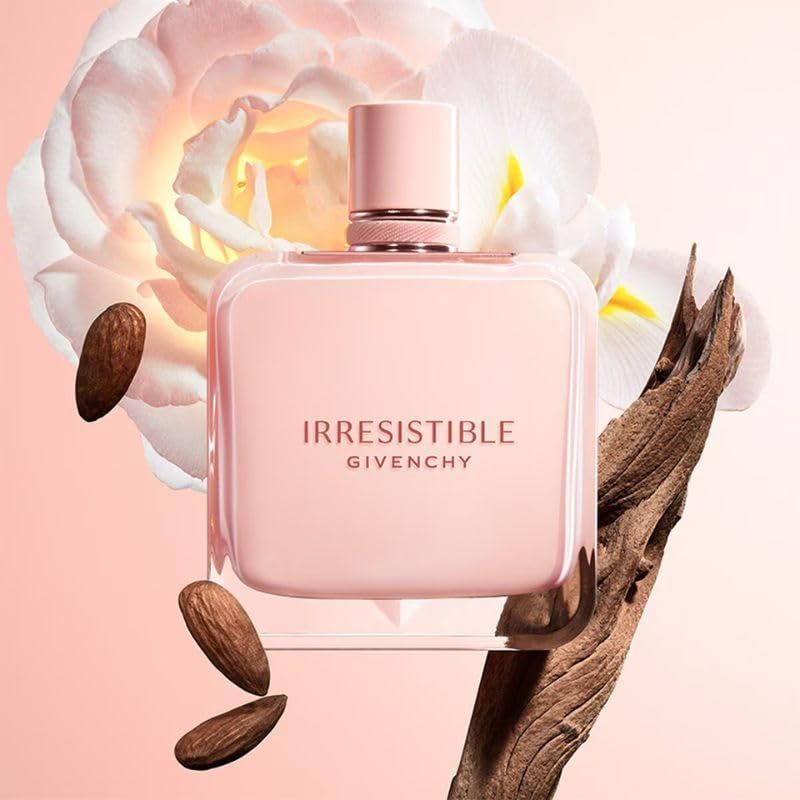 Flacone Givenchy Irresistible Nude Velvet Eau de Parfum. Flacone rosa con scritta, circondato da fiori, mandorle e legno.
