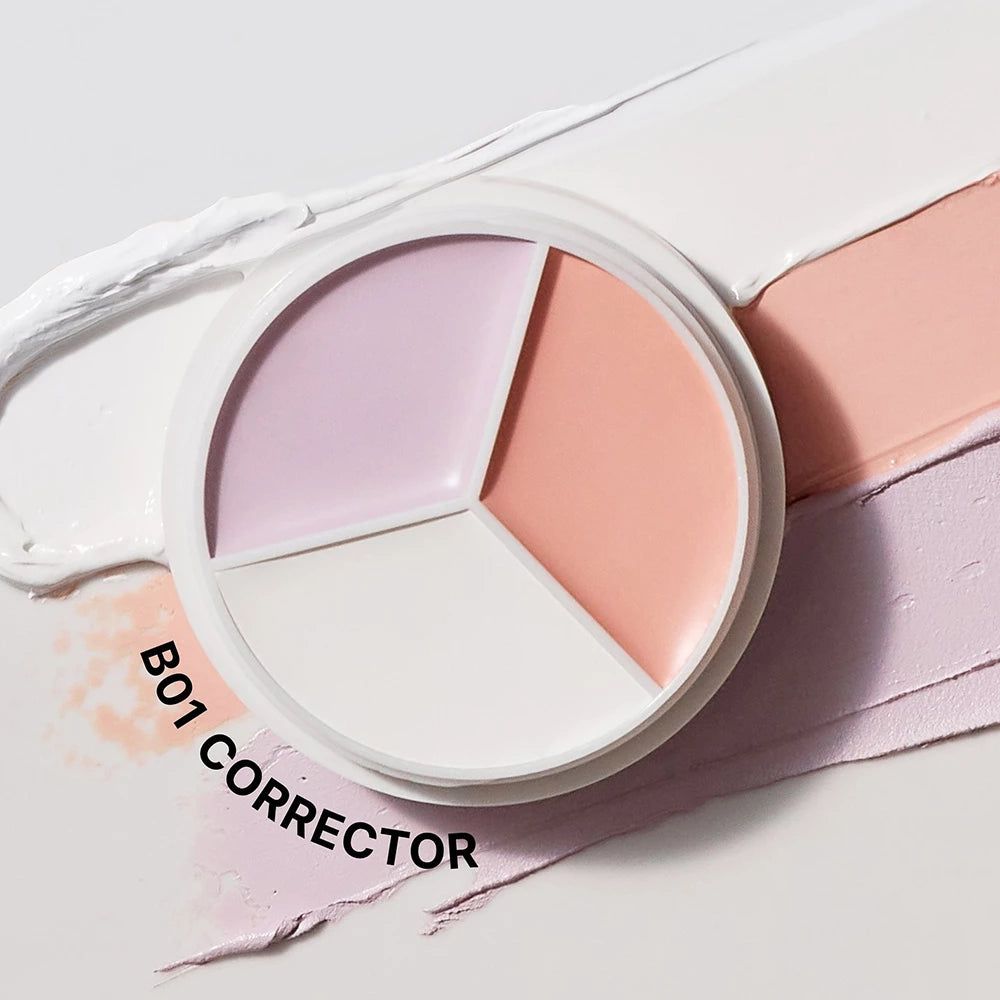 Contenitore rotondo bianco con tre aree colorate: bianco, rosa e lilla. Testo: B01 CORRECTOR.